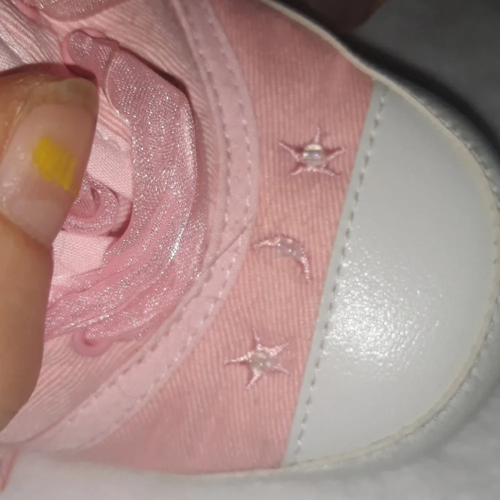 Pink baby sneakers with moon and star beaded accents and fun laces